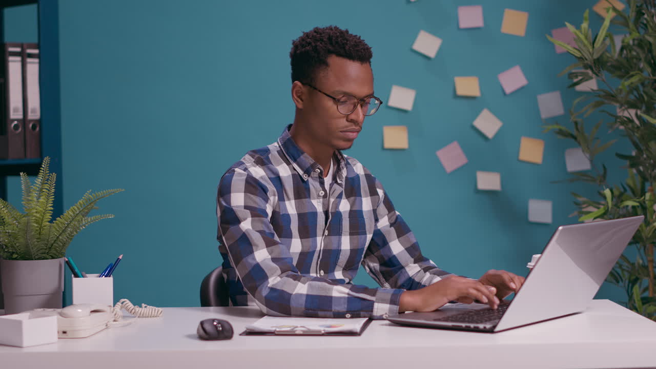 Disappointed employee sitting with arms crossed at office job