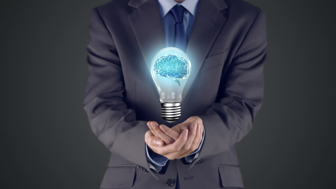 Businessman presenting light bulb with hands