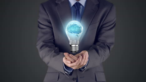 businessman presenting light bulb with hands