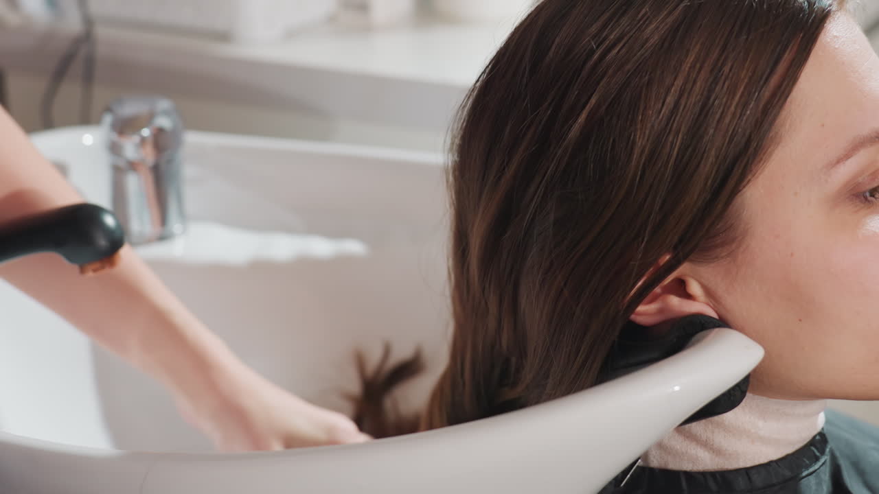 atmosfera rilassante da salone con acconciatura sicura, stilista esperto che crea delicatamente un elegante raccolto, processo di sistemazione dei capelli raffinato che si svolge in un ambiente tranquillo del salone da uno stilista esperto