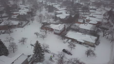 aerial drone view of a snow covered residential neighbourhood on a cold, winter day