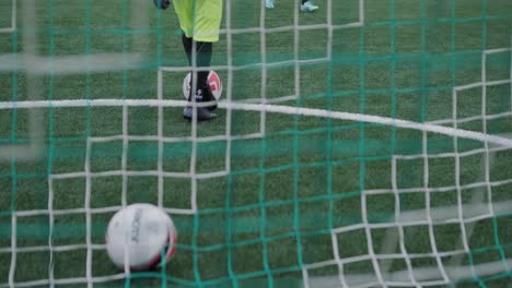 a children's football team trains at the stadium under the guidance of a coach. kids in sports uniforms practice ball exercises, improve technique, and develop teamwork on the green field