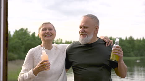 a couple of senior friends dancing and having a drink