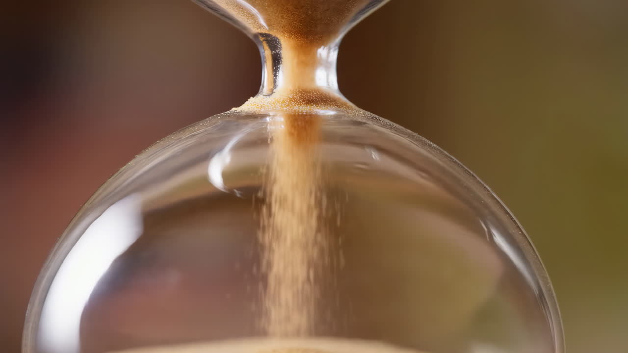 Close-up of Sand Flowing in an Hourglass