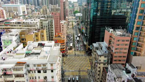 Downtown-Hong-Kong-buildings,-Crosswalk-and-traffic,-High-altitude-aerial-view