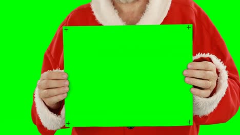 Mid-section-of-santa-claus-holding-blank-placard