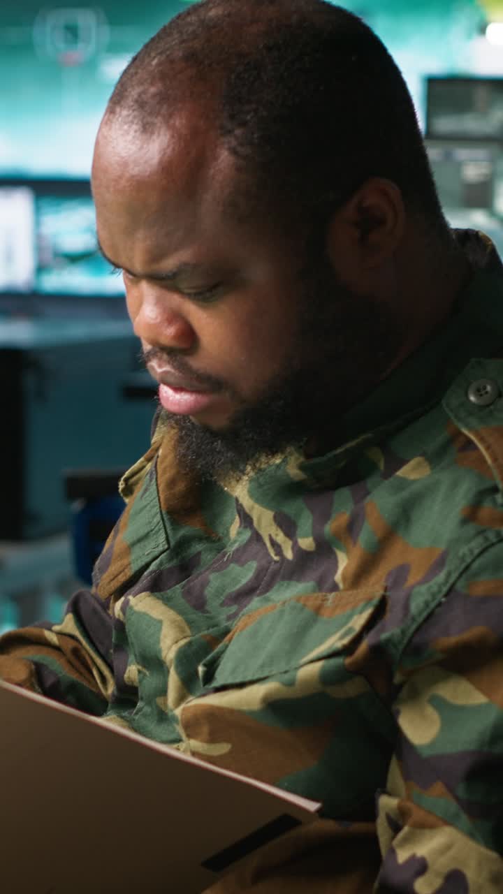 Vertical video Counterintelligence specialist in military HQ base gathering information