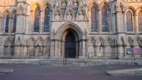 push in towards front entrance doors of large english cathedral in historic city of york