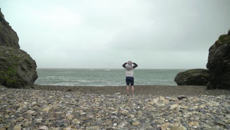 Man-on-the-beach-alone-with-beautiful-surroundings-in-Ireland