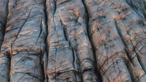 rising, tilting aerial of glacial ice texture. iceland