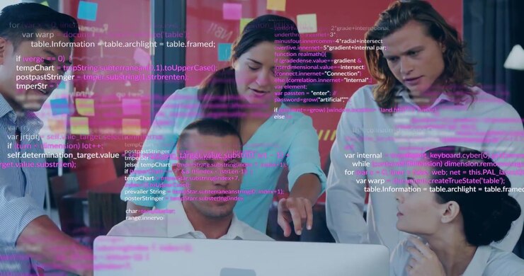 Tech team gathering at desk code overlay appearing above monitor pointing sparking bug fix