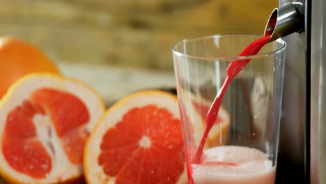 grapefruit with juice maker on wooden table 4k