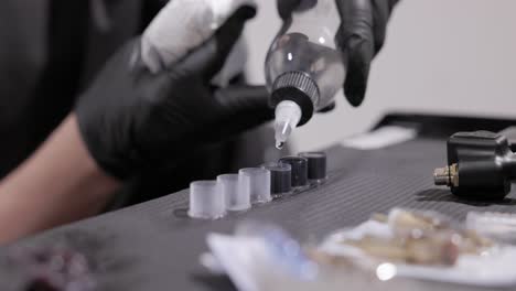 dispensing ink into the cap for application in the tattooing process - close up