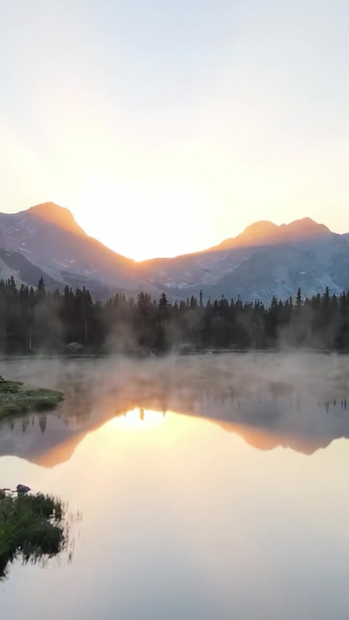 A Tranquil Dawn Over the Misty Lake and Majestic Mountains: A Serene Reflection of Natural Beauty at Sunrise