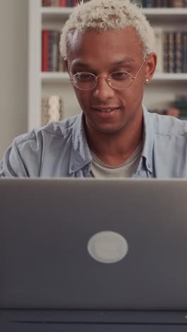 young african american man freelancer opens laptop and starts doing work