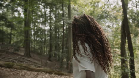 Following-from-behind-a-young-adult-black-woman-hiking-through-the-woods-in-northern-Michigan