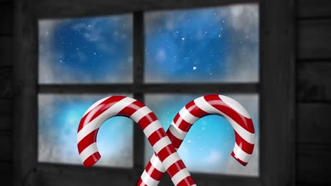 Animation-Von-Weihnachtsdekorationen-Mit-Zuckerstangen-Und-Einer-Winterlandschaft,-Die-Durch-Das-Fenster-Gesehen-Wird