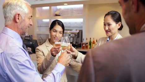 business partners celebrating after work and drinking wine