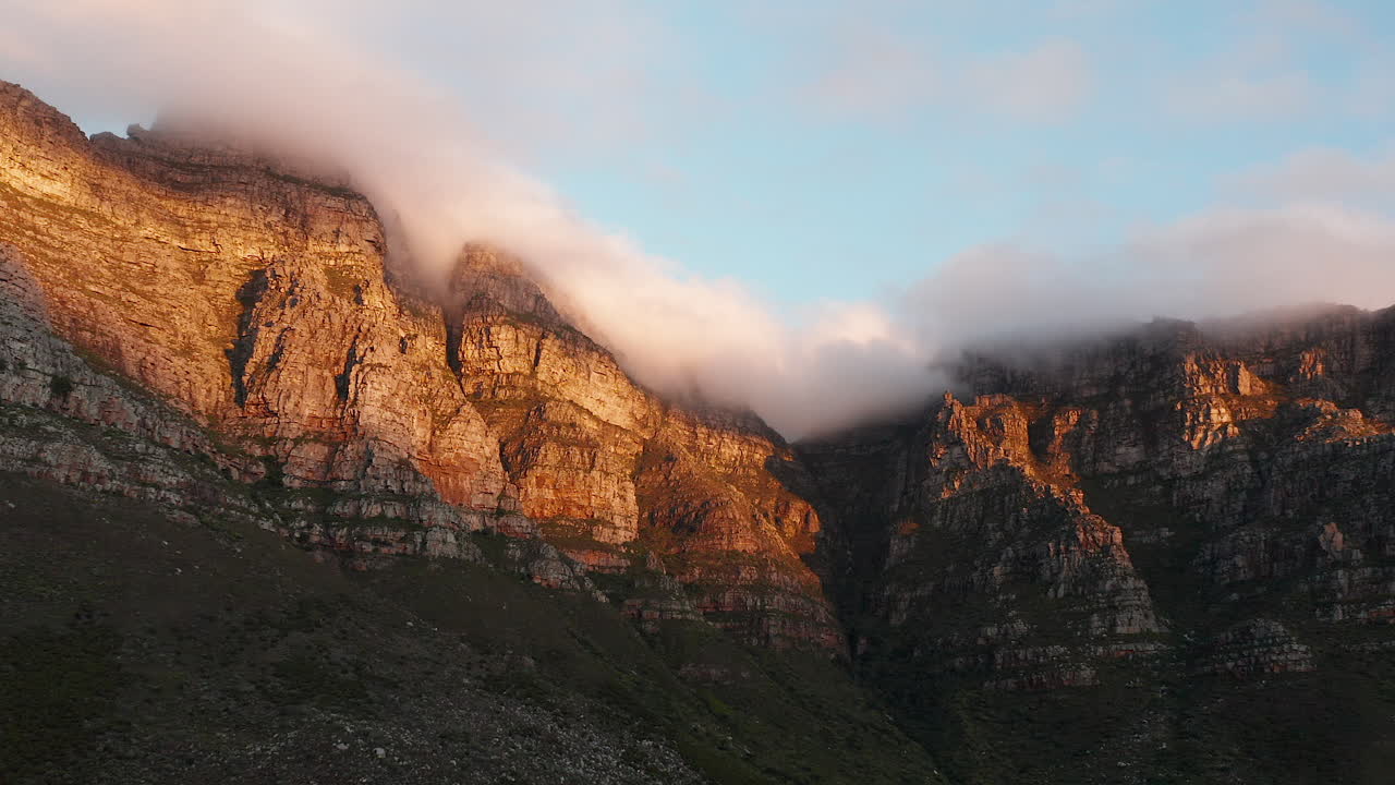 Aerial of Table Mountain viewing Kasteelspoor hiking trail with clouds on top of the mountain in Cape Town, South Africa