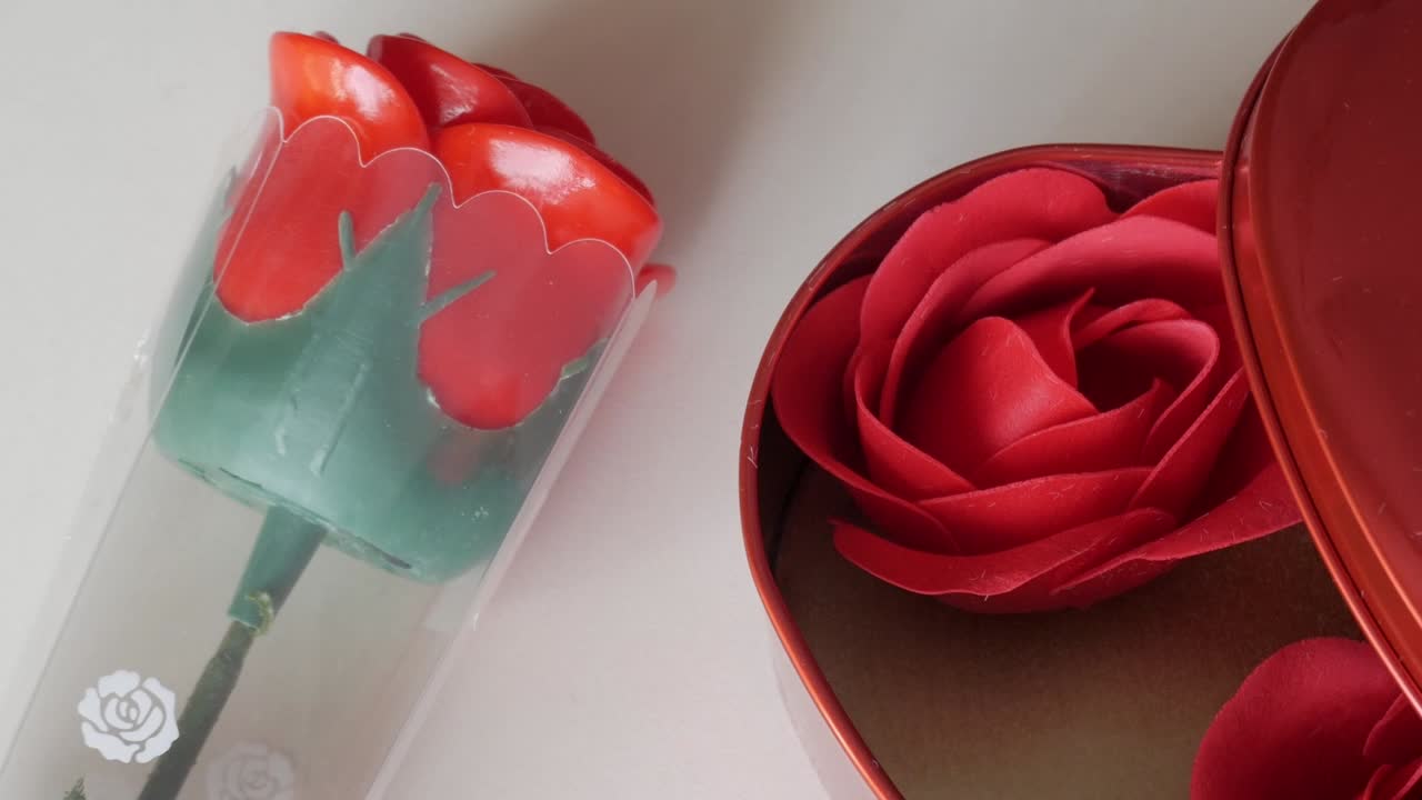 A rose displayed in a transparent vase and a red rose in a gift box, showing beauty and elegance