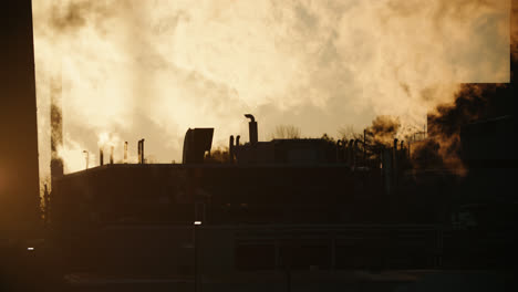 chemical factory emitting thick toxic smoke pollution during sunset