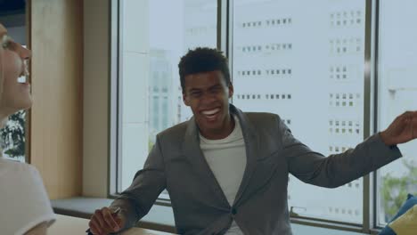 laughing black man with colleagues in office