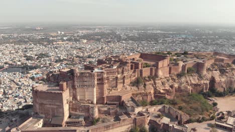 Fly-over-Mehrangarh-fort-overseeing-the-city-of-Jodhpur,-Rajasthan,-India