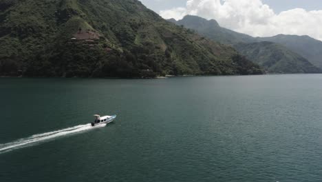 motorboat creating wake while speeding across lake atitlan in guatemala