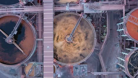 top down drone shot of metal and coal factory waste or water purification tank, queensland australia 4k