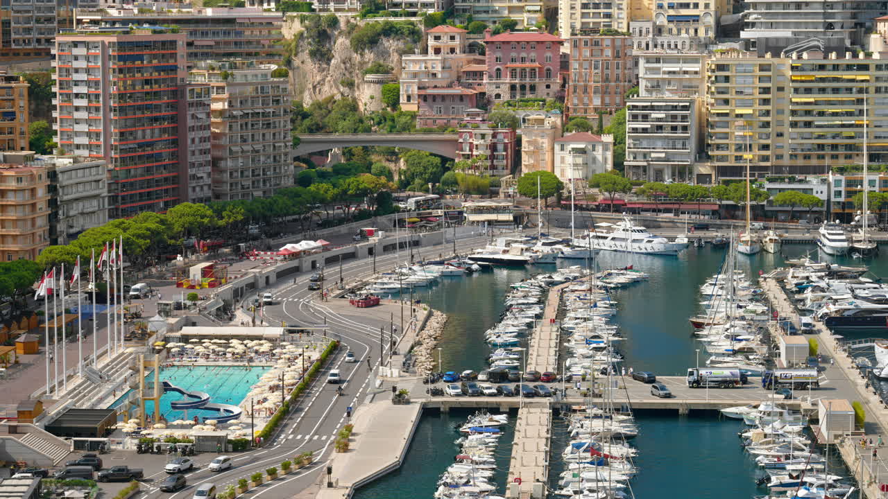 View of boats docked in the Monaco Marina with the skyline of the city on the background