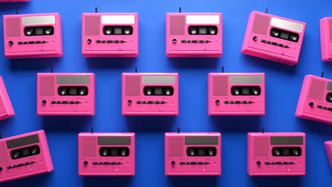 pink cassette players pattern on blue background