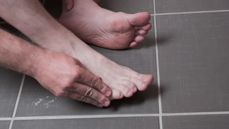 man removing corn, callus from his feet using a razor file, masculine skin care, skin disease, fungal infection, skin treatment