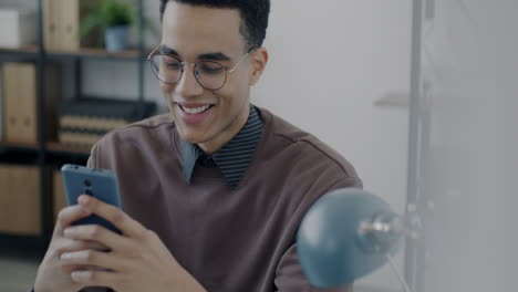 young man using smartphone in office
