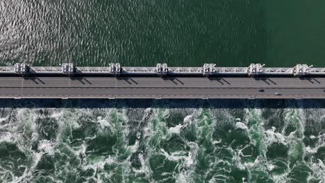 aerial view of the surge barrier at oosterschelde with cars driving across it