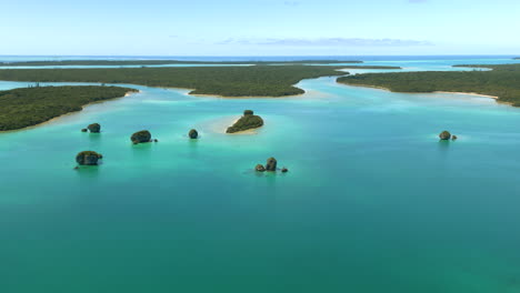 small rock islets in upi bay, isle of pines new caledonia - aerial flyover