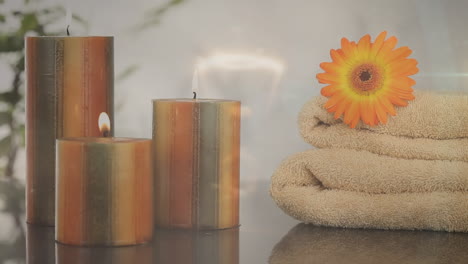 animation of lights over candles, flower and towels