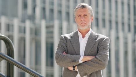 portrait of a confident senior businessman in an urban setting