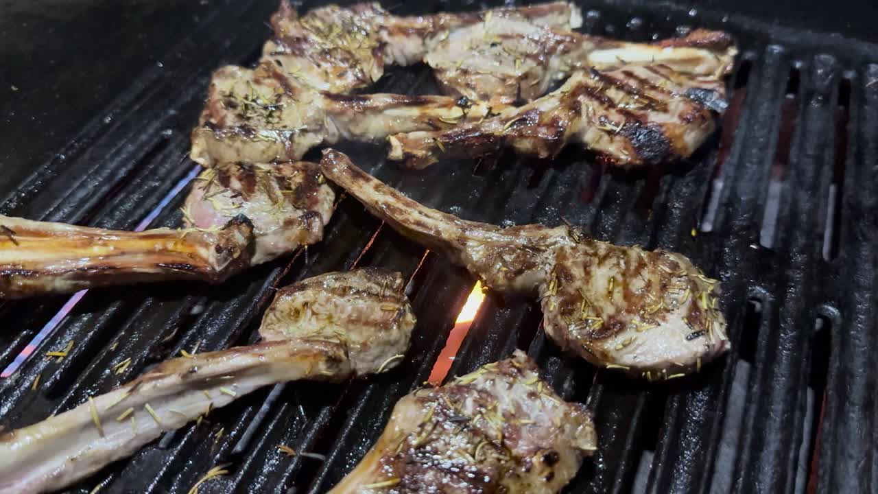 Lamb chops sizzling on a barbecue grill