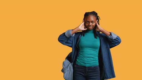 Woman-covering-eyes,-ears-and-mouth-with-hands,-studio-background