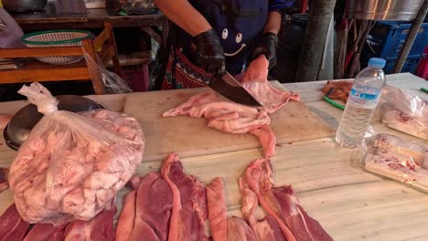 person expertly cutting and preparing meat