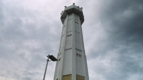 tilt up slow motion shot of the tower in nusa penida on the port bali, indonesia while cloudy weather