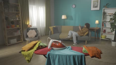 person ironing clothes at home