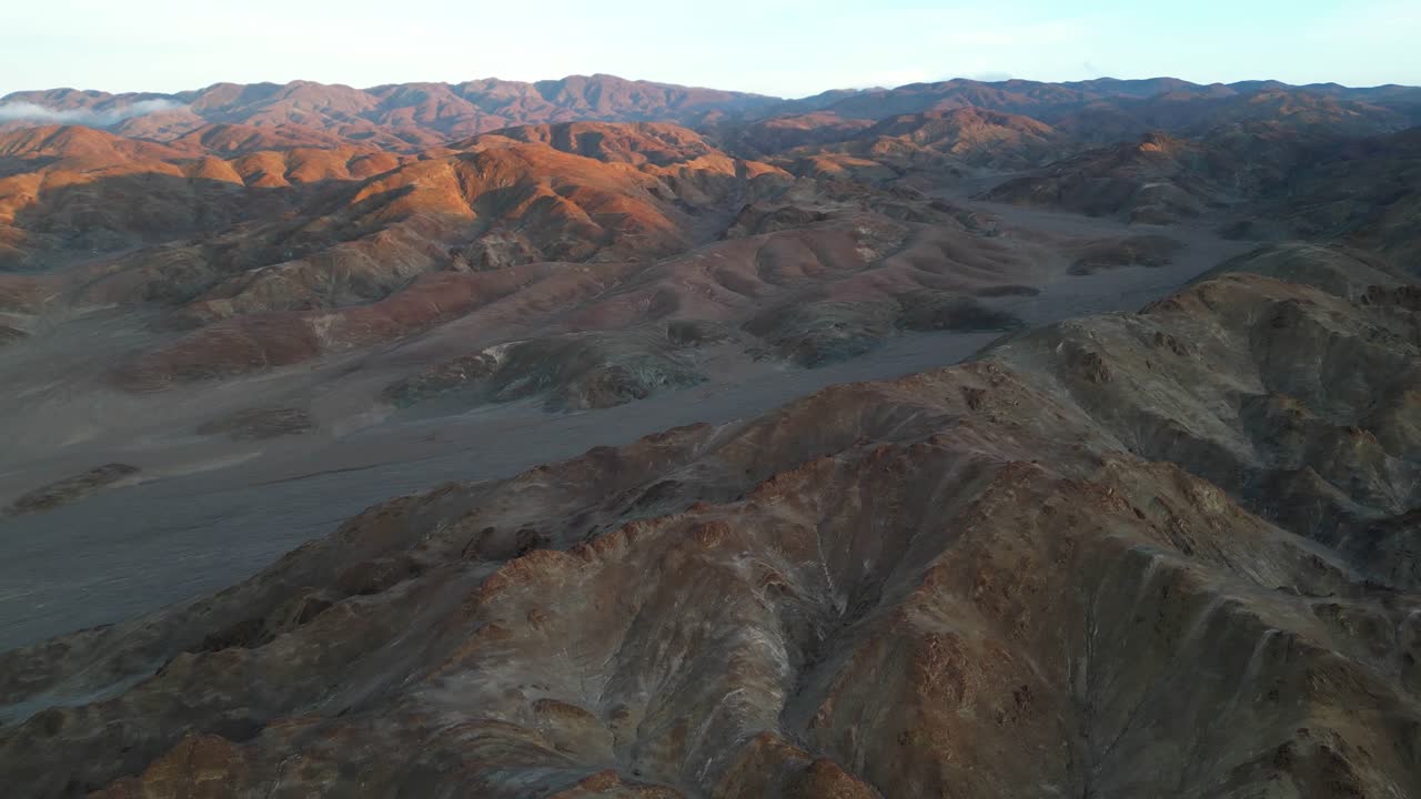 Drone footage of Pan de Azúcar’s barren, Martian-like landscape, with sunrise casting long shadows over rocky desert valleys