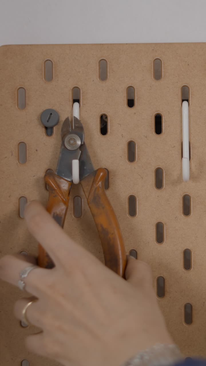 Placing pliers on a pegboard