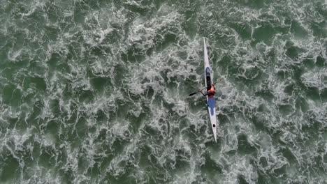 birds eye view of a person kayaking at lagoon beach in cape town south africa