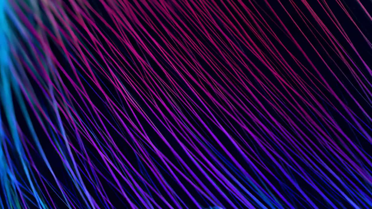 Dynamic close-up of glowing fiber optics in neon colors, perfect for tech video backdrops