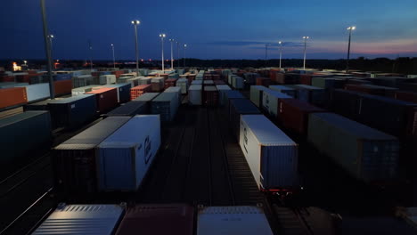 aerial view of a large shipping container freight yard at night