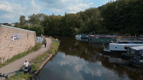 Aerial-footage-of-a-English-canal-with-anglers,-fishermen-fishing-For-Roach-and-Bream