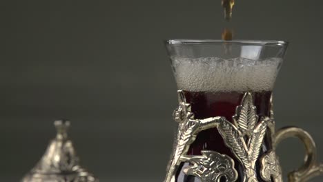 serving turkish çay in traditional metal cup