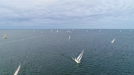 aerial flyover ocean with cruising sailing boats during regatta championship race